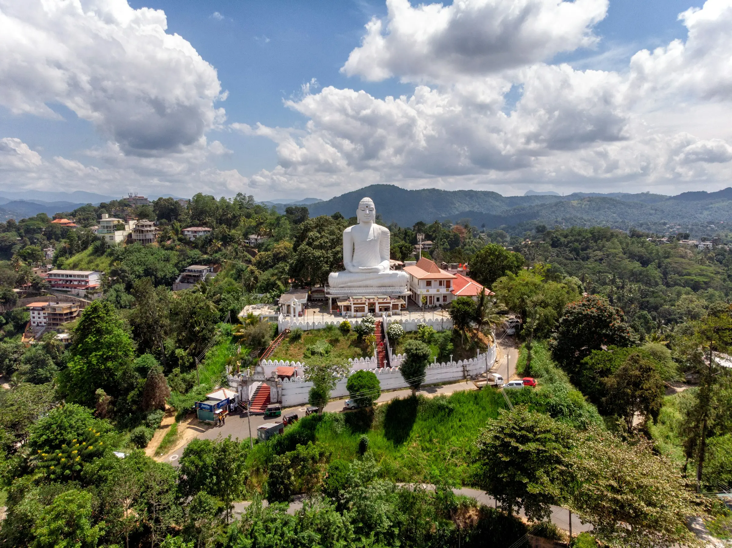 A large seated Buddha statue against an open sky