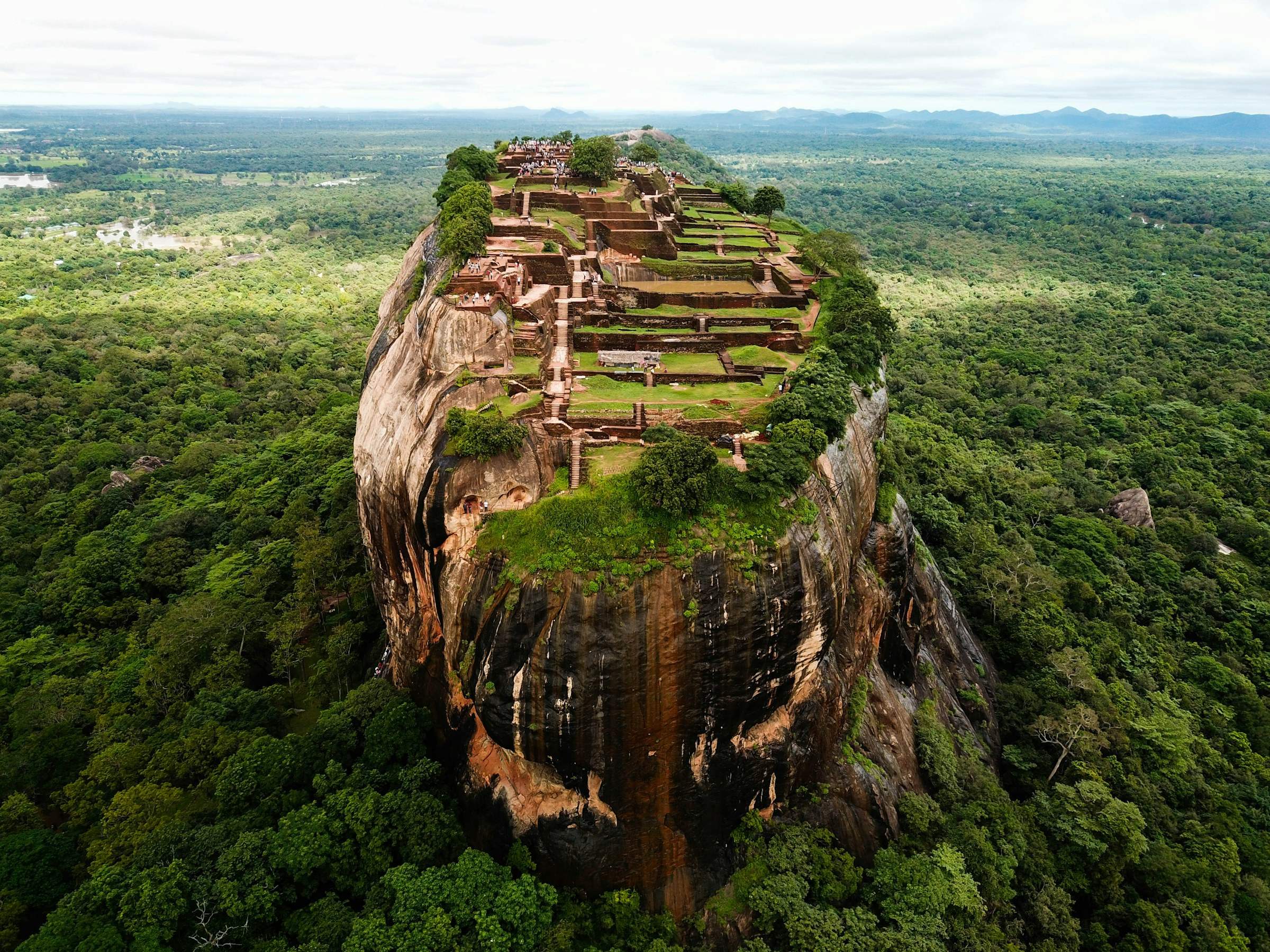 Aerial view of Sigiriya rock fortress with its summit ruins and surrounding forest